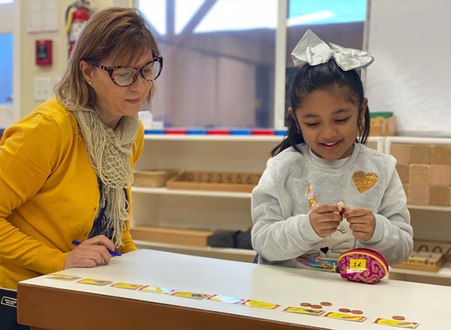 Montessori School at Washington Avenue teacher working with daycare child