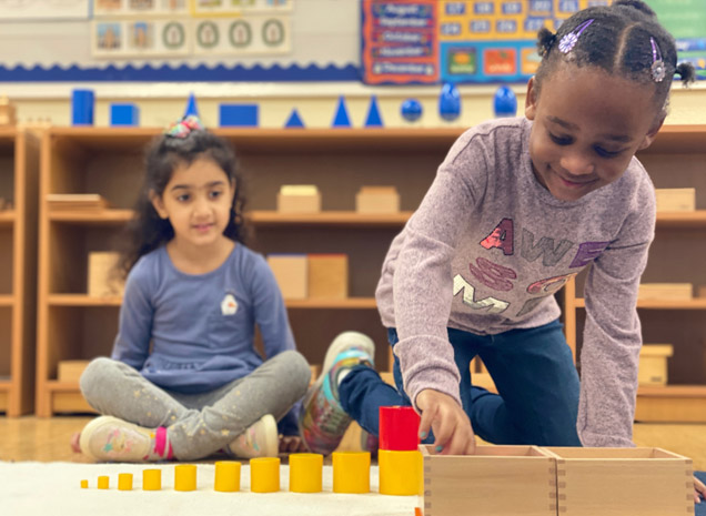 Montessori School at Washington Ave teacher working with a preschool/kindergarten child