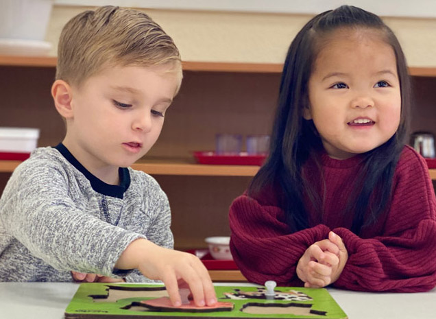 Montessori School at Washington Avenue teacher working with two year old toddler program